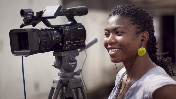 Female African journalist with video camera