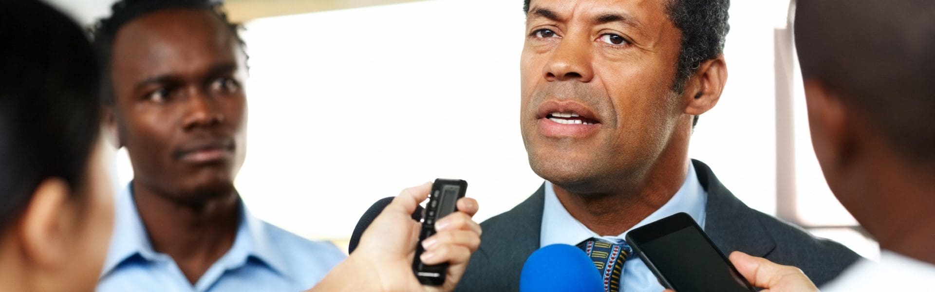 Mature African man answering to journalists during a press conference